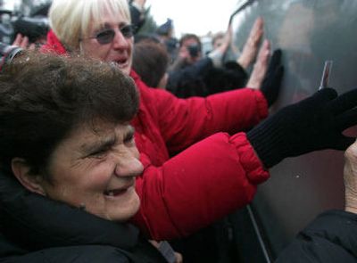 
 Supporters meet the hearse bearing late Serbian and Yugoslav President Slobodan Milosevic at the  Belgrade airport Wednesday. 
 (Associated Press / The Spokesman-Review)