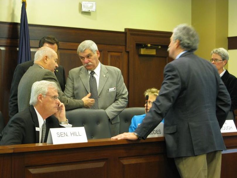 Lawmakers on the revenue committee, including Sen. John Goedde, center, and Sen. Brent Hill, left, confer during a break in their meeting Thursday. (Betsy Russell)