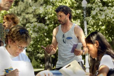 
Terrence Cochran talks with a paralegal in Riverfront Park on Saturday. 
 (Christopher Anderson/ / The Spokesman-Review)