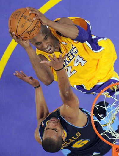 Los Angeles Lakers guard Kobe Bryant, top, goes up for a shot as Denver Nuggets guard Arron Afflalo attempts to defend. (Associated Press)