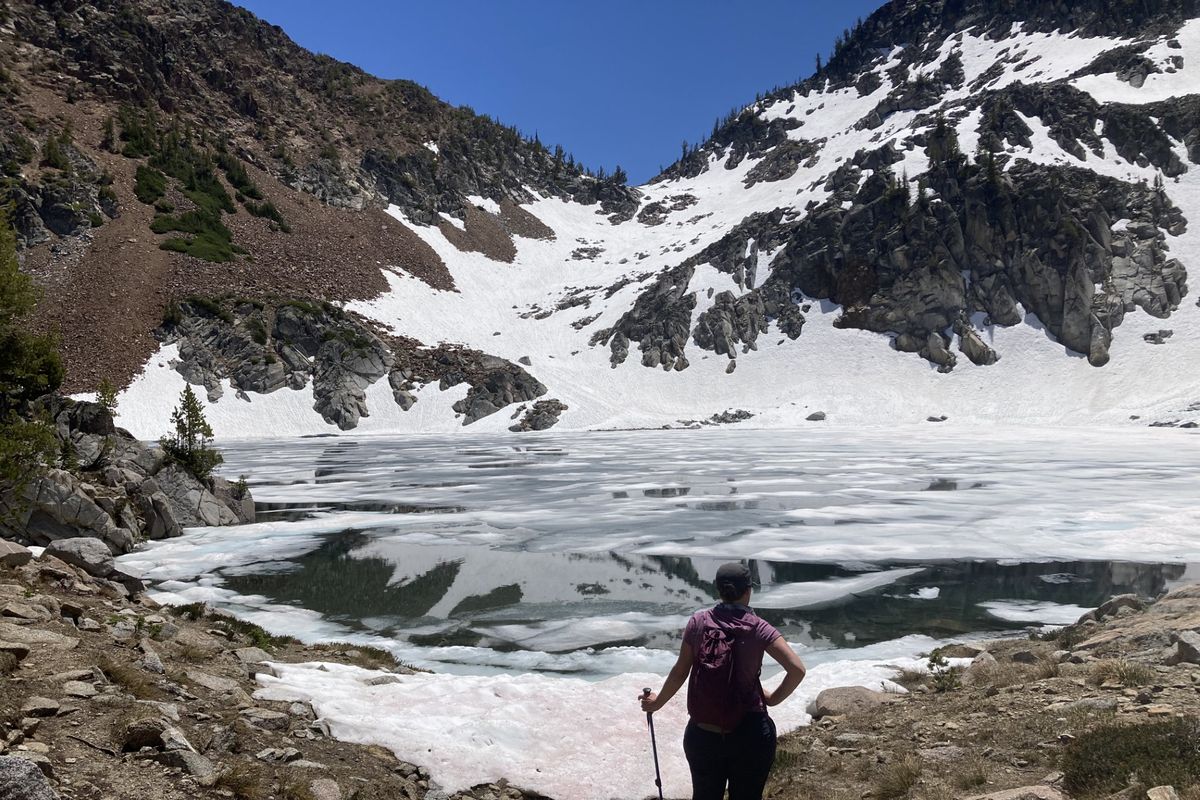 Kim Guida, a family practice doctor from Pullman, surveys the scene at Echo Lake in the Wallowa Mountains of northeastern Oregon.   (William Brock/For The Spokesman-Review)