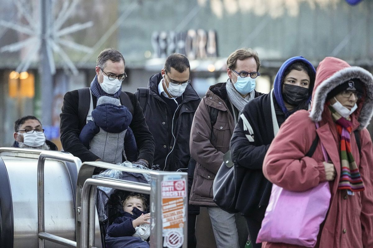 Commuters wearing face masks to protect against COVID-19 ride a escalator at La Defense business district in Paris, Wednesday, Dec. 8, 2021. The new potentially more contagious omicron variant of the coronavirus popped up in more European countries just days after being identified in South Africa, leaving governments around the world scrambling to stop the spread.  (Michel Euler)