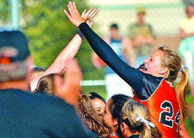 
Post Falls' pitching and hitting star Blake Meredith, far right, receives accolades after the Trojans eliminated Lake City at region. 
 (Kathy Plonka / The Spokesman-Review)