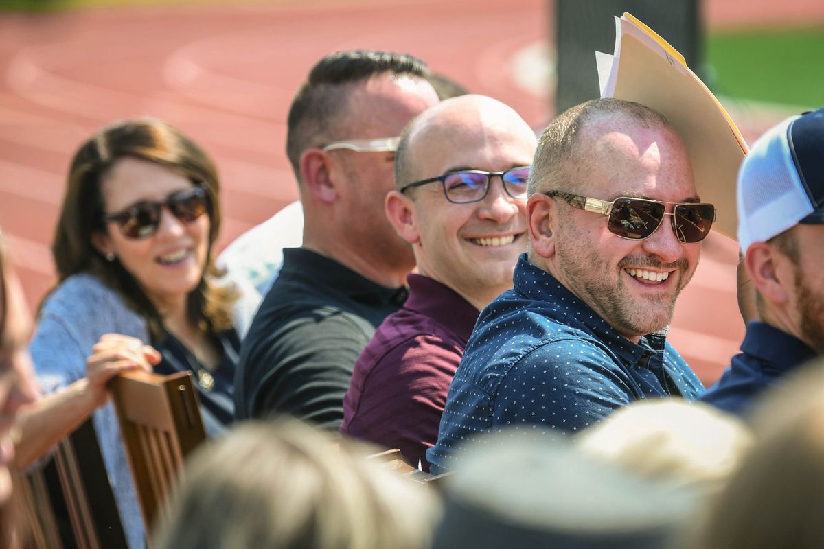 Laughing at some of the memories during the memorial service for Sally Jackson are, from left, Sen. Maria Cantwell, Matt Fleming, Chris Jackson and Casey Jackson on Saturday at the University High School football field. (DAN PELLE/THE SPOKESMAN-REVIEW)