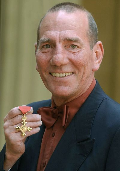 A Wednesday, June 9, 2004 photo from files showing  British actor Peter Postlethwaite displaying his Order of the British Empire or OBE, shortly after the presentation at Buckingham Palace in London. (Kirsty Wigglesworth / Associated Press)