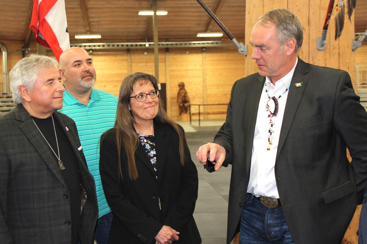 Spokane Tribe Chair Carol Evans, center, smiles and listens to Secretary of the Interior Ryan Zinke, right, during a visit by Zinke to the Powow Pavillion in Wellpinit Thursday, Mar. 22, 2018. At left are Glenn Ford and Danny Kieffer, tribal council members. Photo by Becky Kramer (Becky Kramer / The Spokesman-Review)