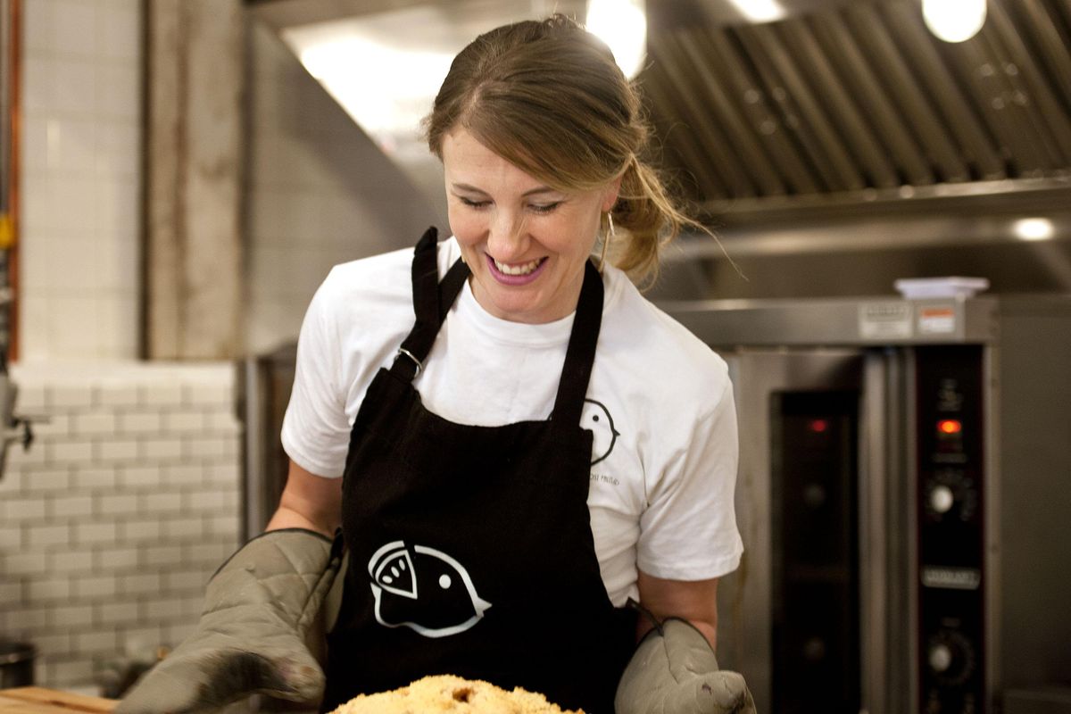 Sharee Moss of Birdie’s Pie Shop takes a fresh baked apple pie out of the oven at the shop in Post Falls on Jan. 8. (Kathy Plonka / The Spokesman-Review)