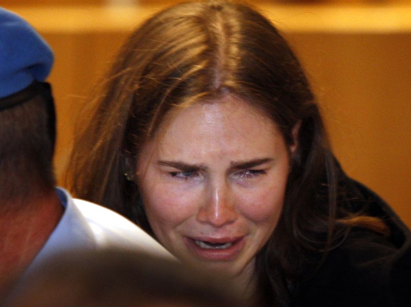 Amanda Knox breaks down in tears after hearing the verdict that overturns her conviction and acquits her of murdering her British roommate Meredith Kercher, at the Perugia court, central Italy, Monday, Oct. 3, 2011. Italian appeals court threw out Amanda Knox's murder conviction Monday and ordered the young American freed after nearly four years in prison for the death of her British roommate Knox collapsed in tears after the verdict overturning her 2009 conviction was read out. Her co-defendant, Italian Raffaele Sollecito, also was cleared of killing 21-year-old Meredith Kercher in 2007. (Pier Cito / Associated Press)