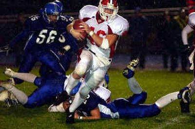 
Sandpoint's Nathan Knaggs (46) rumbles through the rain as the Bulldogs won 17-0 in rainy Coeur d'Alene. 
 (Tom Davenport/ / The Spokesman-Review)