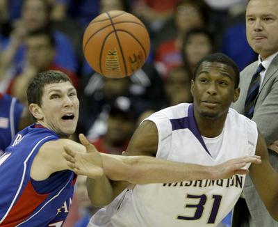 Kansas guard Tyrel Reed, left, knocks the ball away from Washington guard Elston Turner during the first half.  (Associated Press / The Spokesman-Review)