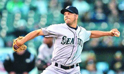 
Mariners pitcher Jarrod Washburn allowed three Oakland batters to reach base after the fourth inning while getting the win. 
 (Associated Press / The Spokesman-Review)