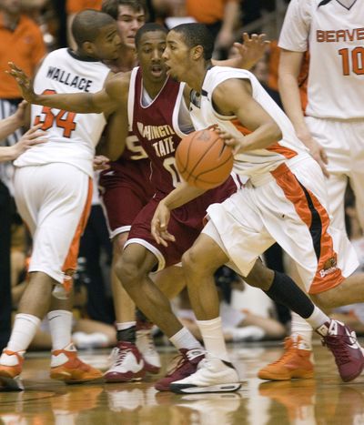 OSU guard Josh Tarver, right, drives on Marcus Capers.  (Associated Press / The Spokesman-Review)
