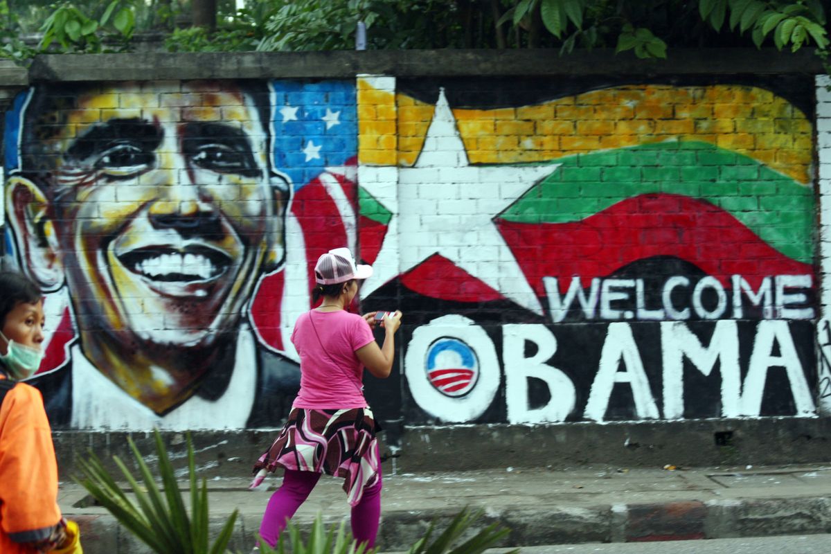 A woman takes a photo of a wall painting created by Myanmar graffiti artists to welcome U.S. President Barack Obama on a street in Yangon, Myanmar, Saturday, Nov. 17, 2012. Obama will visit Myanmar on Monday, in a first for a sitting U.S. president. White House officials on Thursday said he will use his visit "to lock down progress and to push on areas where progress is urgently needed" � most notably freeing political prisoners and ending ethnic tensions in the western state of Rakhine and the northern state of Kachin. Obama