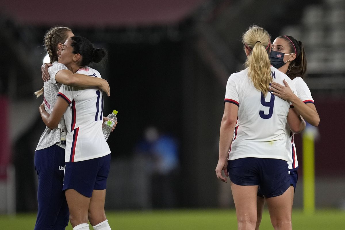 United States players embrace after being defeated 1-0 by Canada during a women’s semifinal soccer match at the 2020 Summer Olympics Monday.  (Andre Penner)