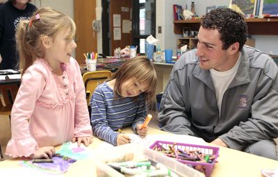 Carroll’s Chanler Buck talks to McHenry Primary students Destanie Huckaby, left, and Hannah Raburn at an NAIA function.  (Associated Press / The Spokesman-Review)