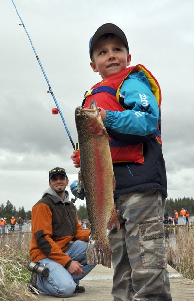 Carson Blakesley of Post Falls caught one of the few really big rainbows swimming with the more average-sized trout in the net pens set up at Clear Lake for the annual Kids Fish-In on May 1. Colby Price, in the background, caught a big one, too. Both boys are 5 years old. RICH LANDERS richl@spokesman.com
 (Rich Landers)
