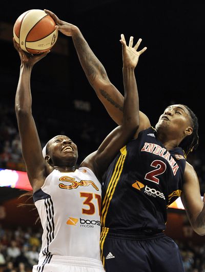 Tina Charles, left, deftly draws a foul on Indiana’s Erlana Larkins. (Associated Press)