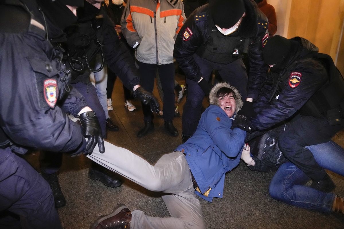 Police officers detain demonstrators in St. Petersburg, Russia, Thursday, Feb. 24, 2022. Hundreds of people gathered in Moscow and St.Petersburg on Thursday, protesting against Russia