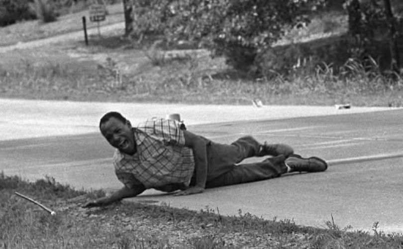 Civil rights activist James Meredith grimaces in pain as he pulls himself across Highway 51 in Hernando, Miss. after being shot during a voting rights march, June 6, 1966. Meredith, who defied segregation to enroll at the University of Mississippi in 1962, completed the march from Memphis, Tenn., to Jackson, Miss., after treatment of his wounds. He will be the featured speaker at a Walk the Talk conference in Coeur d'Alene next month. (AP Photo/Jack Thornell)