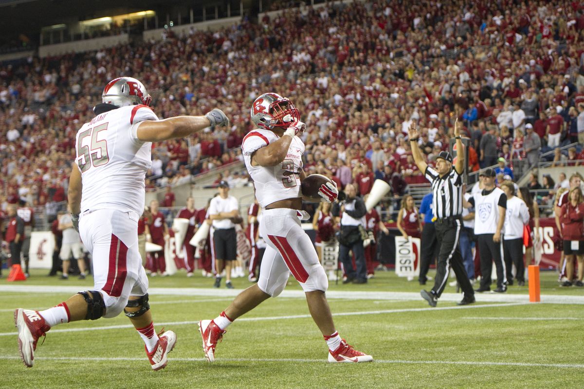 Rutgers running back Paul James, right, reacts after scoring the game-winning touchdown against WSU on Thursday. (Tyler Tjomsland)