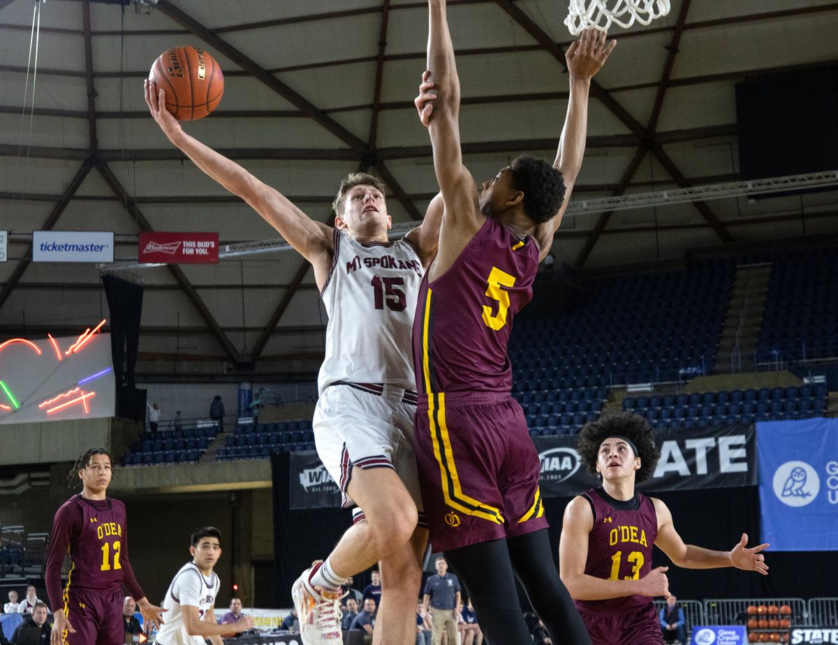 Mt. Spokane’s Maverick Sanders drives against the defense of O’Dea’s Miles Goodman during Friday’s State 3A semifinal at the Tacoma Dome. Sanders finished with 18 points. but the Wildcats lost 57-52.  (Patrick Hagerty)