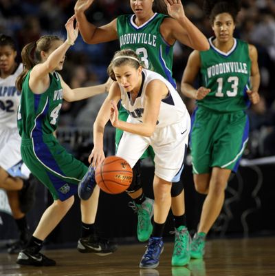 Gonzaga Prep's Laura Stockton, middle, blows through three Woodinville defenders during action in the 4A Girls State Basketball Tournament Thursday at the Tacoma Dome. (Patrick Hagerty / The Spokesman-Review)