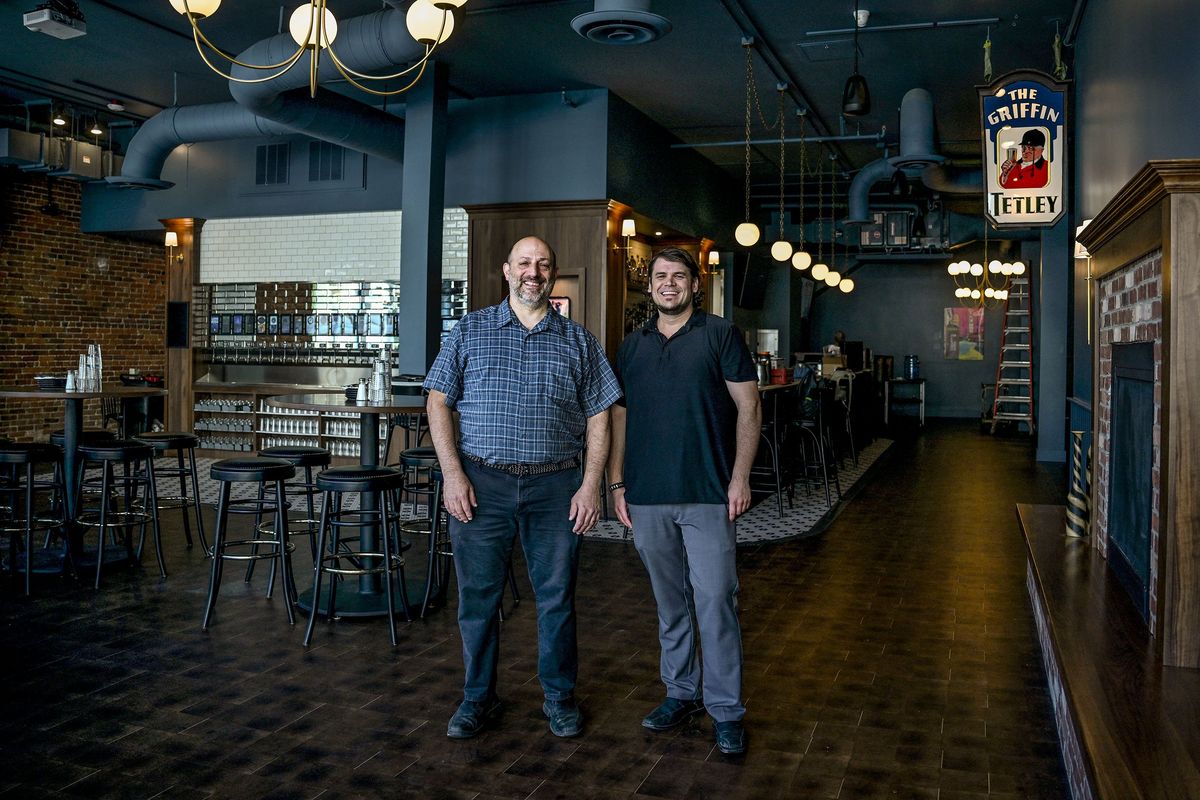 Mike Sichel, left, general manager for Gilded Unicorn, and Jeff Cooney, general manager for Griffin Tavern Kitchen and Taphouse, hang out Thursday at the tavern in Spokane. (Kathy Plonka/The Spokesman-Review)