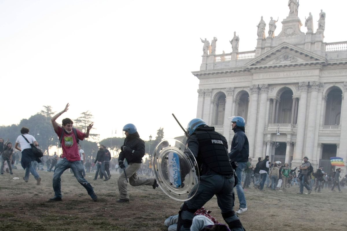 A police officer subdues a protester in front of the Basilica of St. John Lateran during clashes Saturday in Rome. A demonstration against corporate greed that was part of Occupy protests turned into a riot. (Associated Press)