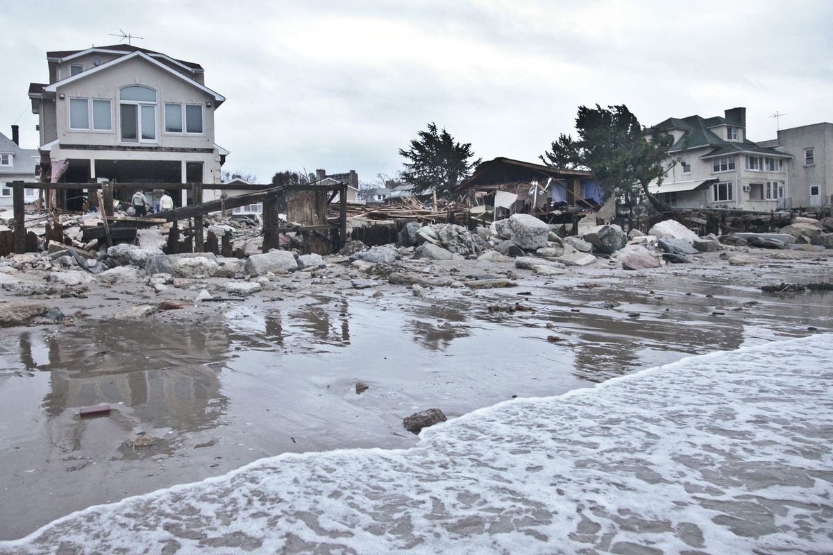 A beachfront house is damaged in the aftermath of yesterday