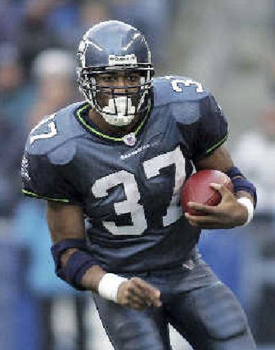 
Seattle's Shaun Alexander, the NFL's leading rusher, is leaving contract talks to his agent. 
 (Associated Press / The Spokesman-Review)