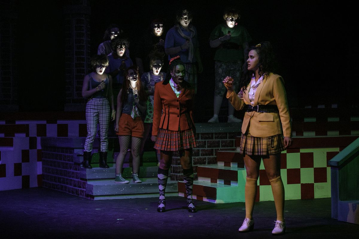 Torey Rouston (red) and Victoria Scribner (yellow) plus members of the ensemble in “Heathers: The Musical” at Spokane Civic Theatre.  (Courtesy of Marlee Melinda Andrews)