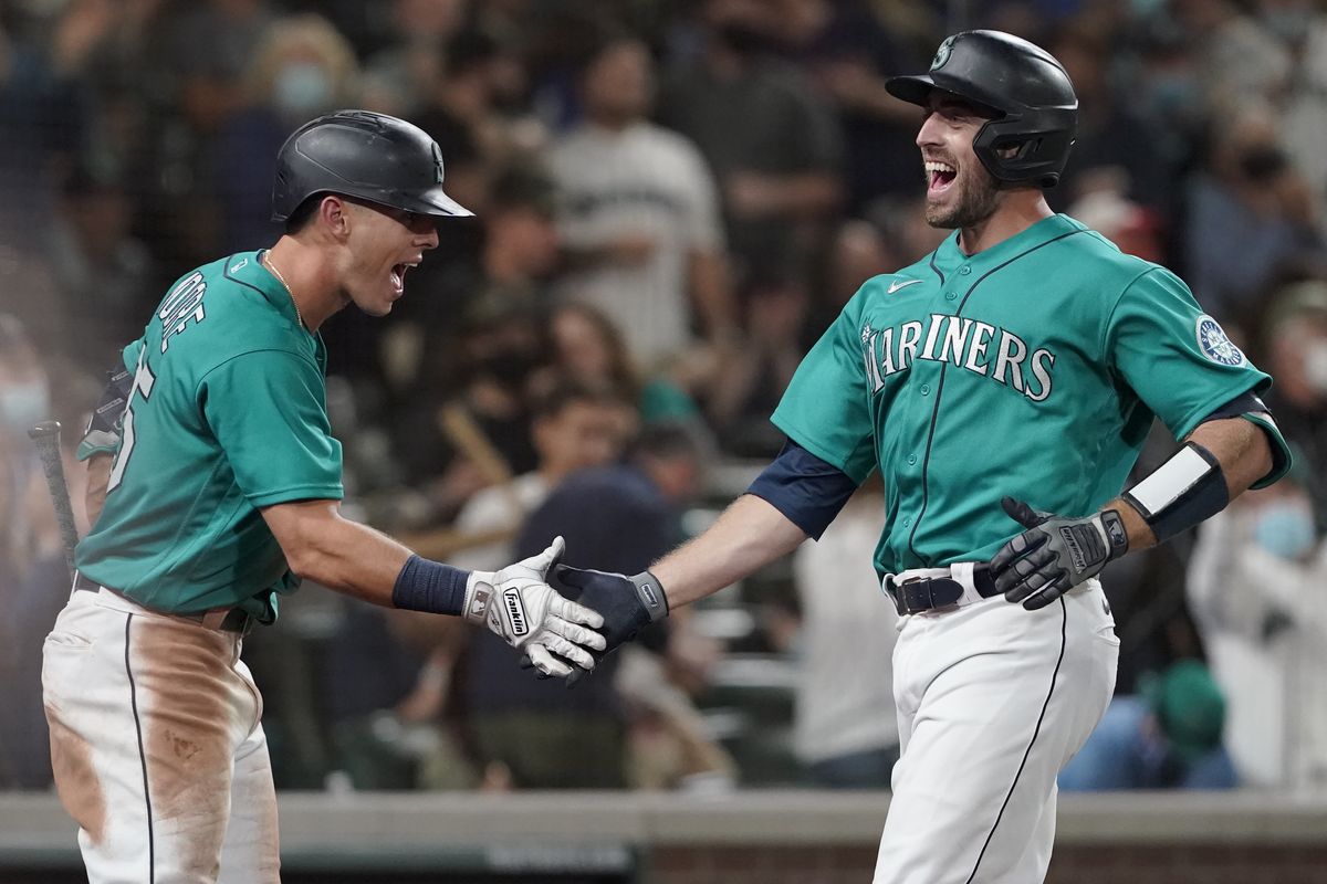 Seattle’s Tom Murphy, right, is greeted by Dylan Moore after Murphy hit a solo home run during the sixth inning of a 5-4 win over Arizona on Friday in Seattle. The homer was Murphy’s second in the game.  (Ted S. Warren)