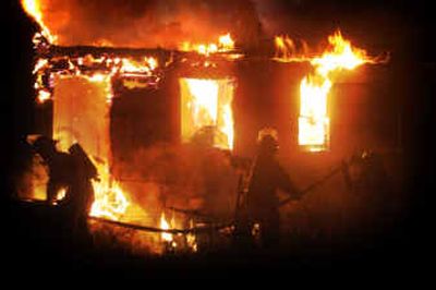 
Firefighters battle a blaze at the Skyline Motel at 1724 W. Geiger on Friday night. 
 (Jed Conklin / The Spokesman-Review)