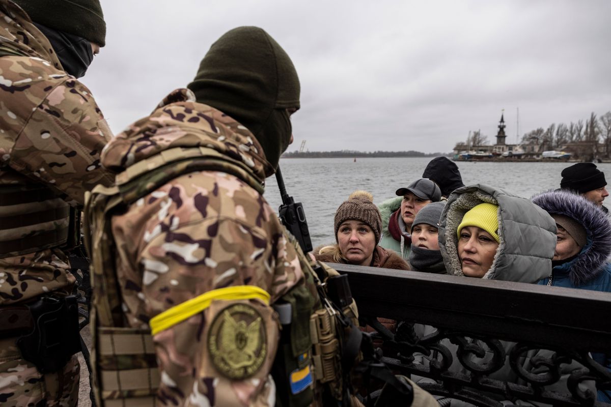 Women plead with Ukrainian forces on Sunday to take a boat to the eastern side of the Dnieper River, where families are in Russian-occupied territory. Ukraine began allowing, but not facilitating, westward crossings on Saturday, but few have been willing or able to make the trip. A woman was killed attempting to do so with her husband.    (Heidi Levine/For The Washington Post)