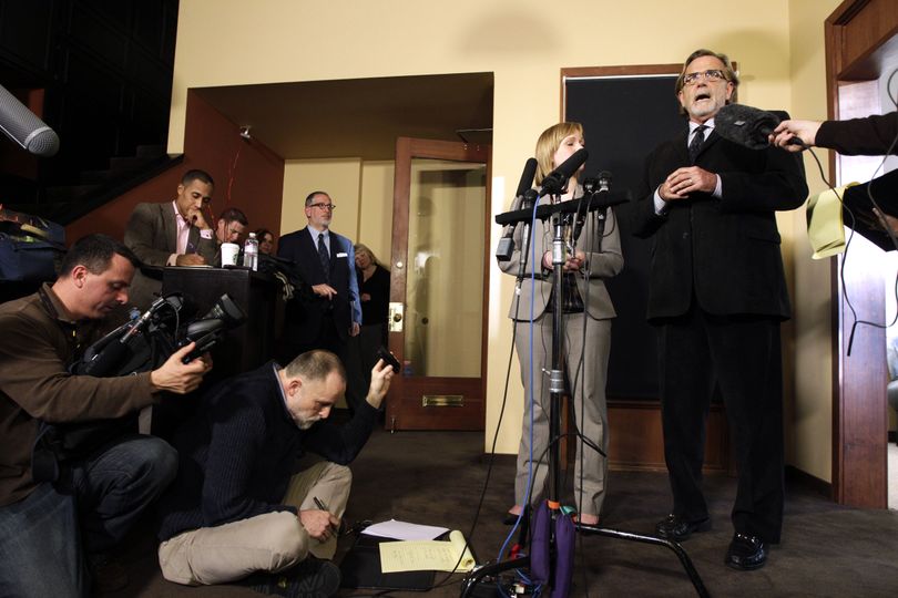 Attorneys John Henry Browne, right, and Emma Scanlan, second from right, talk to reporters, Thursday, March 15, 2012, in Seattle. Browne and Scanlan will be representing a U.S. soldier accused of killing 16 Afghan civilians. (Ted Warren / Associated Press)
