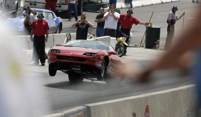 The front wheels of this Super Stock drag racer lift into the air at the starting line at Spokane County Raceway on Sunday afternoon.bartr@spokesman.com (J. BART RAYNIAK / The Spokesman-Review)