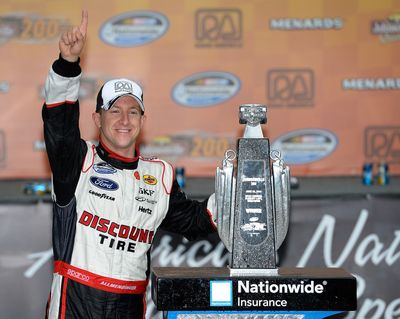 AJ Allmendinger, driver of the #22 Discount Tire Ford, celebrates in victory lane after winning the NASCAR Nationwide Series Johnsonville Sausage 200 Presented by Menards at Road America on June 22, 2013 in Elkhart Lake, Wisconsin. (Photo by John Harrelson/NASCAR via Getty Images) (John Harrelson / Nascar)