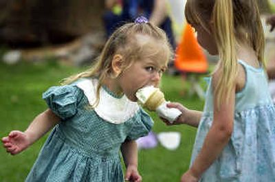 While dancing to the marimba band Coeurimba, Emma Marx, 2, of Moscow, Idaho, is offered a lick from 4-year-old Shaean Johnson's ice cream cone, Friday at ArtFest. The annual art and music festival continues through Sunday at the Museum of Arts and Culture.
(Photos by Colin Mulvany/ / The Spokesman-Review)