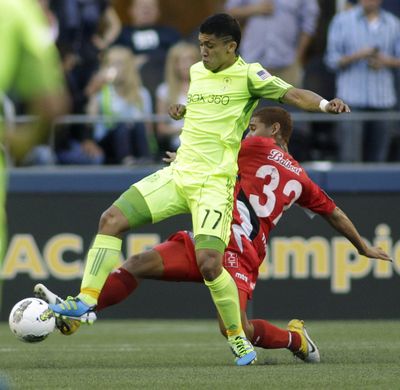 Fredy Montero of the Seattle Sounders, left, battles for the ball with Roberto Chen during Wednesday’s CONCACAF match. (Associated Press)