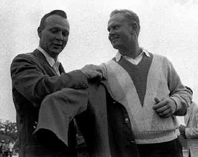 
Arnold Palmer, left, 1964 Masters champion, helps Jack Nicklaus into his second of six green jackets.
 (File/Associated Press / The Spokesman-Review)