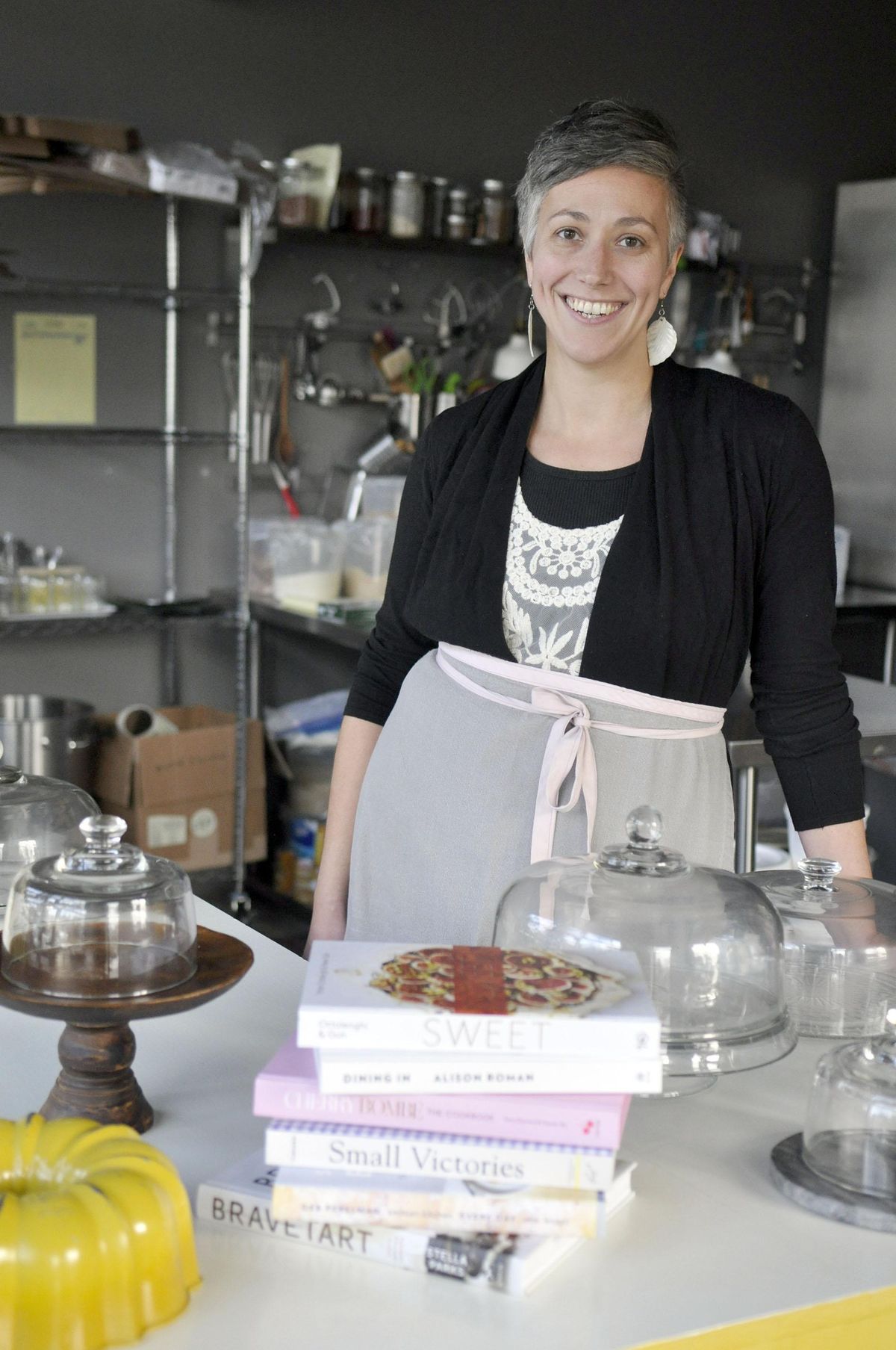 Mika Maloney, owner of Bake Bakeshop, poses for a portrait behind the counter at her business. (Adriana Janovich / The Spokesman-Review)