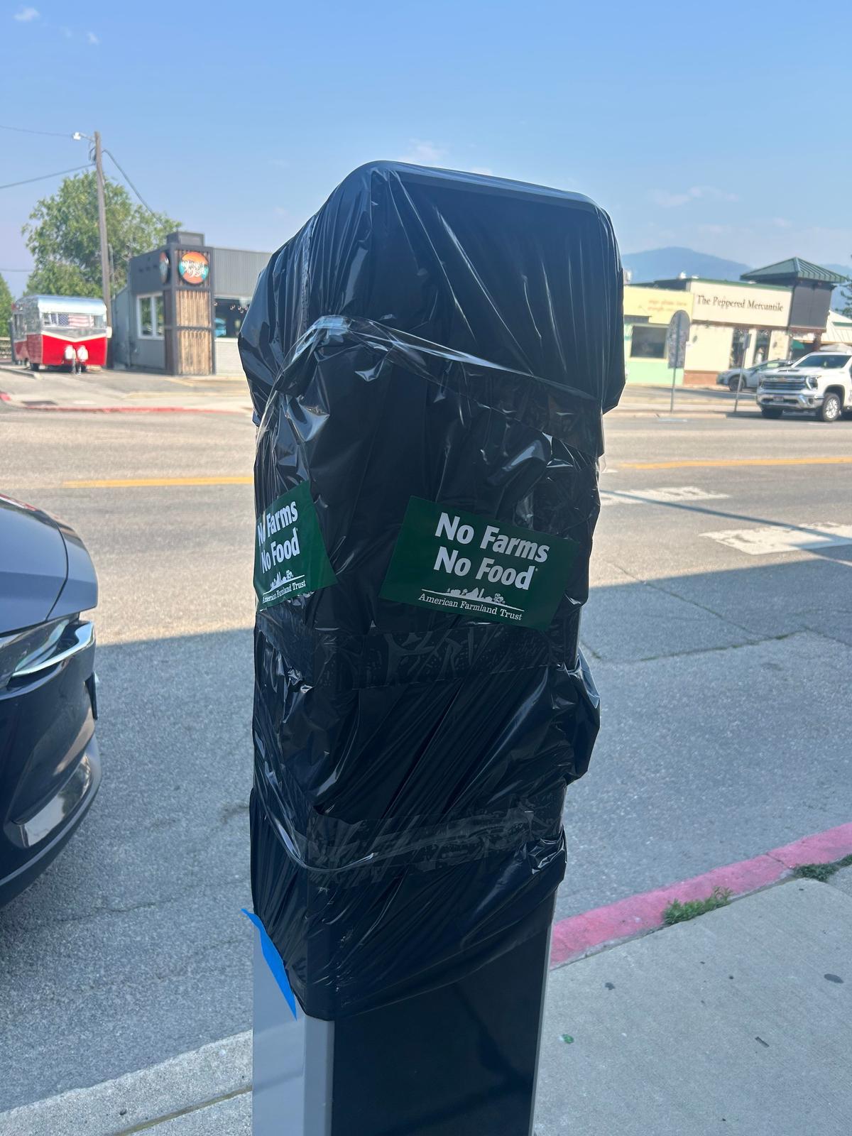 One of the parking kiosks along First Avenue that has a black trash bag draped over it and stickers on it. The Sandpoint City Council voted to suspend the use of on-street parking kiosks within the downtown two-hour parking district for further evaluation on July 15. The next city council meeting is scheduled for Aug. 5.  (Mathew Callaghan / The Spokesman-Review)