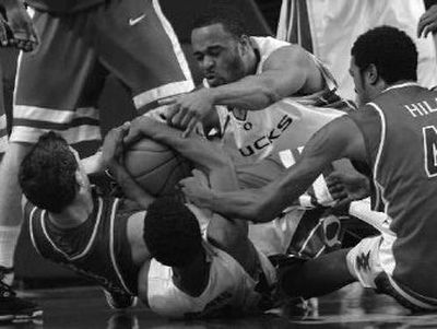 Arizona's Ivan Radenovic, far left, and Jordan Hill battle for the ball against Oregon.
(Associated Press / The Spokesman-Review)