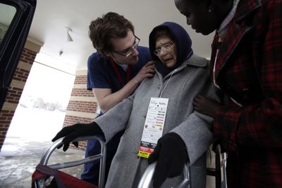 Evelyn Radke is comforted by Anna Charles, right, and Ves Marinov as she and others  are evacuated from the Elim Rehab and Care Center in Fargo, N.D., on Thursday.  (Associated Press / The Spokesman-Review)