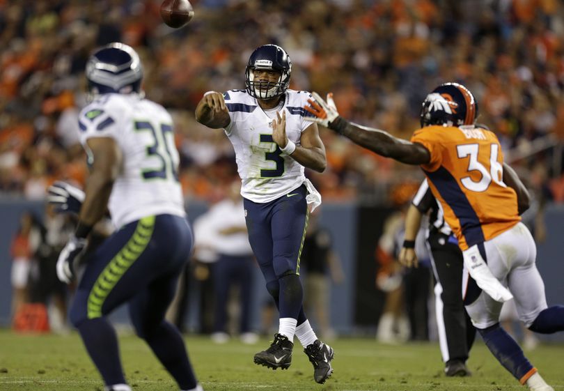 Seattle Seahawks quarterback Russell Wilson throws a second-half touchdown pass to Tyrell Sutton on Saturday. (Associated Press)