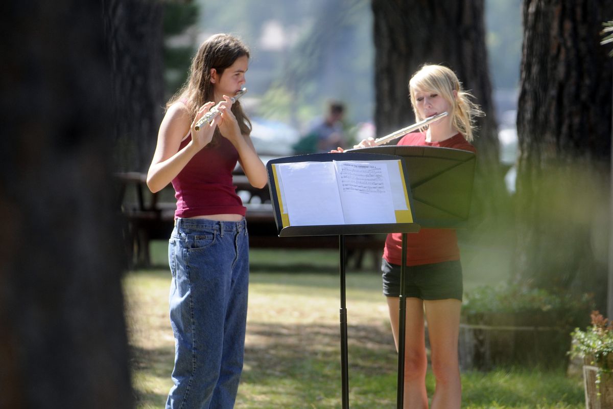Cheney High School student Holly West, 15, plays flute during marching band camp last week. West Valley freshman Stephanie Leberman, left,  and junior Jessica Boyer  practice their part at band camp. The band spent a week at Camp White in Post Falls.bartr@spokesman.com (J. BART RAYNIAK bartr@spokesman.com COLIN MULVANY / The Spokesman-Review)