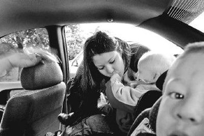 
Coeur d'Alene single mother Emily Whitley, 18, kisses her son Jorden Whitley-Bradley as her other son Taven Whitley-Bradley waits to be buckled in as they get a ride to Project CDA from Emily's grandmother on Tuesday. 
 (Kathy Plonka / The Spokesman-Review)