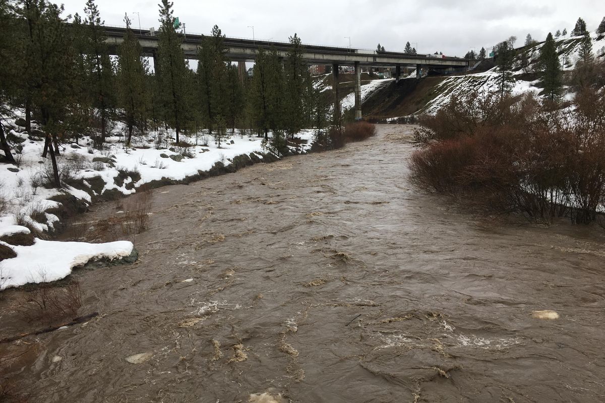 Hangman Creek winds under the Interstate 90 and railroad bridges while swollen with snowmelt and rain Thursday, Feb. 16, 2017. More than a dozen county roads remained closed through the first part of the weekend due to widespread flooding. (Jesse Tinsley / The Spokesman-Review)