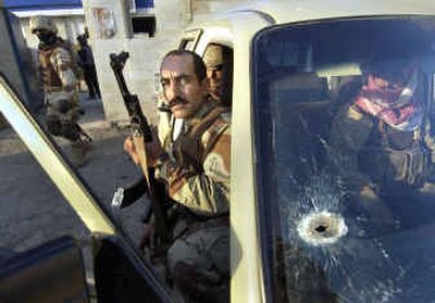 
Iraqi National Guard soldiers set out from an Iraqi police station to recover bodies after two men were found murdered Thursday in Mosul, Iraq. Previously, 20 bodies were found in Mosul in the past week, including 10 identified as Iraqi regular army soldiers. 
 (Associated Press / The Spokesman-Review)