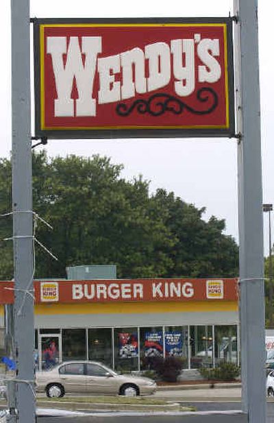 
A Wendy's restaurant sign stands near a neighboring Burger King restaurant in Cold Spring, Ky. Wendy's is neck-and-neck with rival Burger King, poised to take over as the nation's No. 2 restaurant chain.
 (Associated Press / The Spokesman-Review)